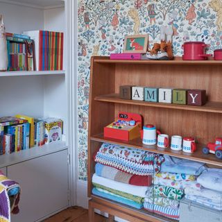 Book shelves in a children's room with colour accessories and books on display