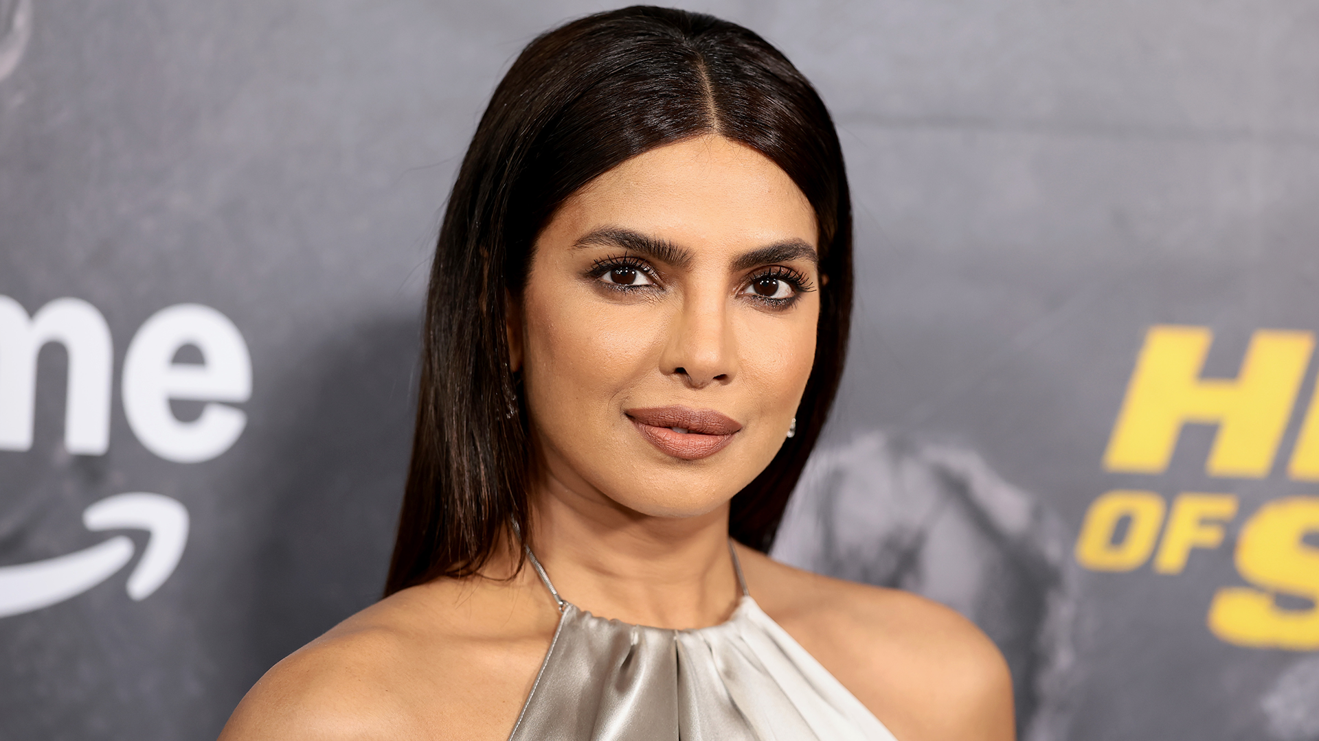 Priyanka Chopra attended the 'Heads of State' premiere in a silver slip dress from Ralph Lauren.