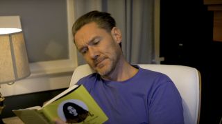 Ben Prendergast reading a book on his YouTube channel