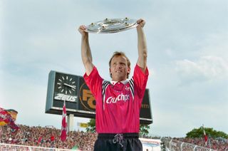 Kaiserslautern's Andreas Brehme holds the Bundesliga trophy, 1998