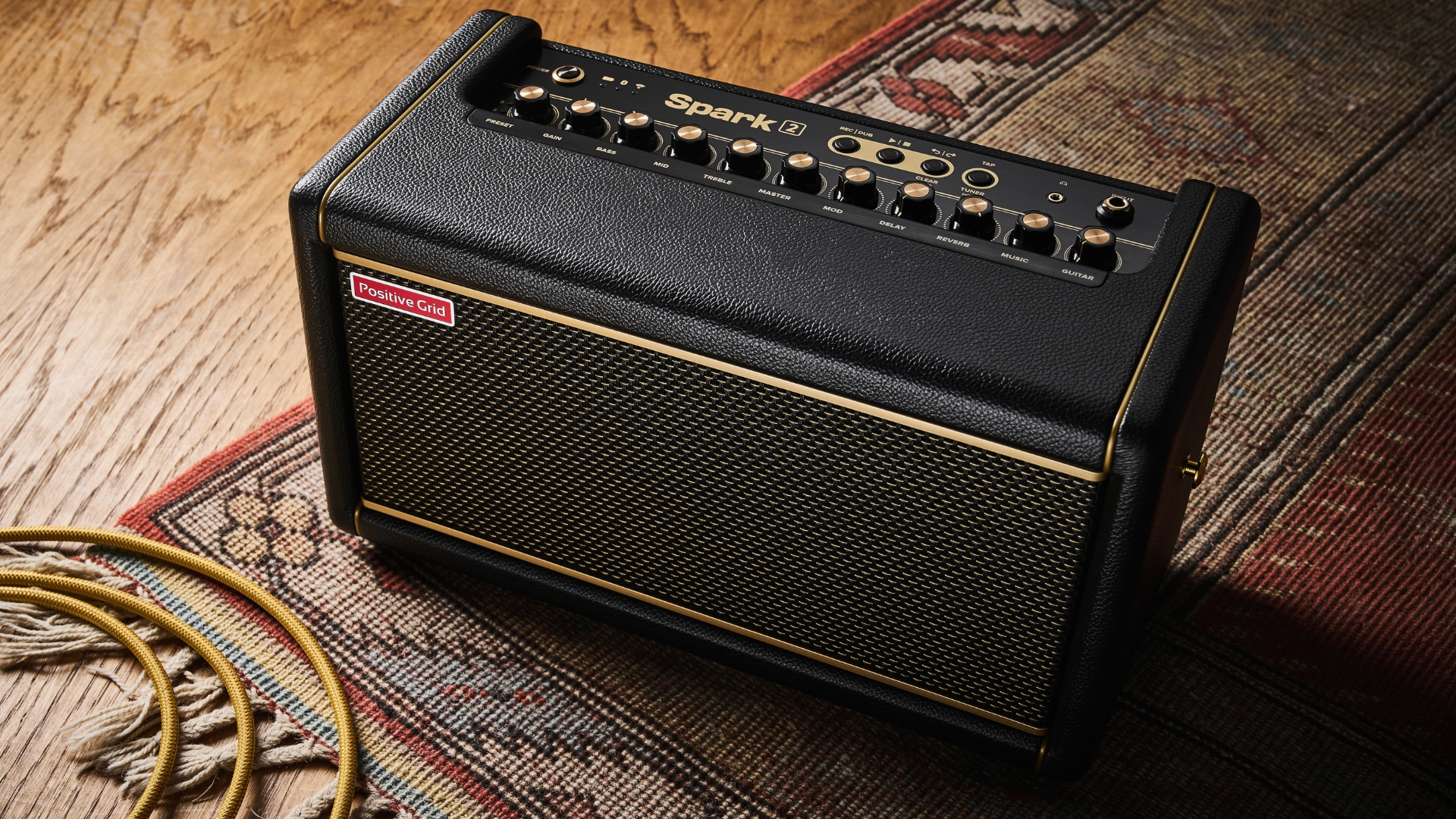 A Positive Grid Spark 2 desktop guitar amp on a rug