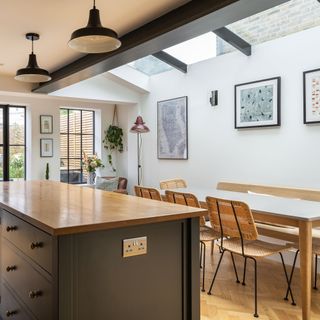 view into a kitchen diner over the kitchen island with a skylight above