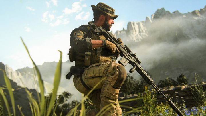 Character in camo holding a gun and kneeling in a field