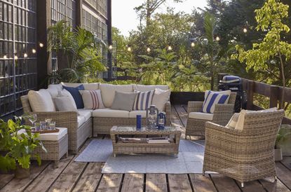 stylish outdoor living room with rugs and festoon lights