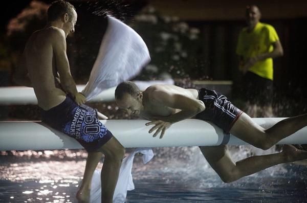 Pillow fight silliness over the pool