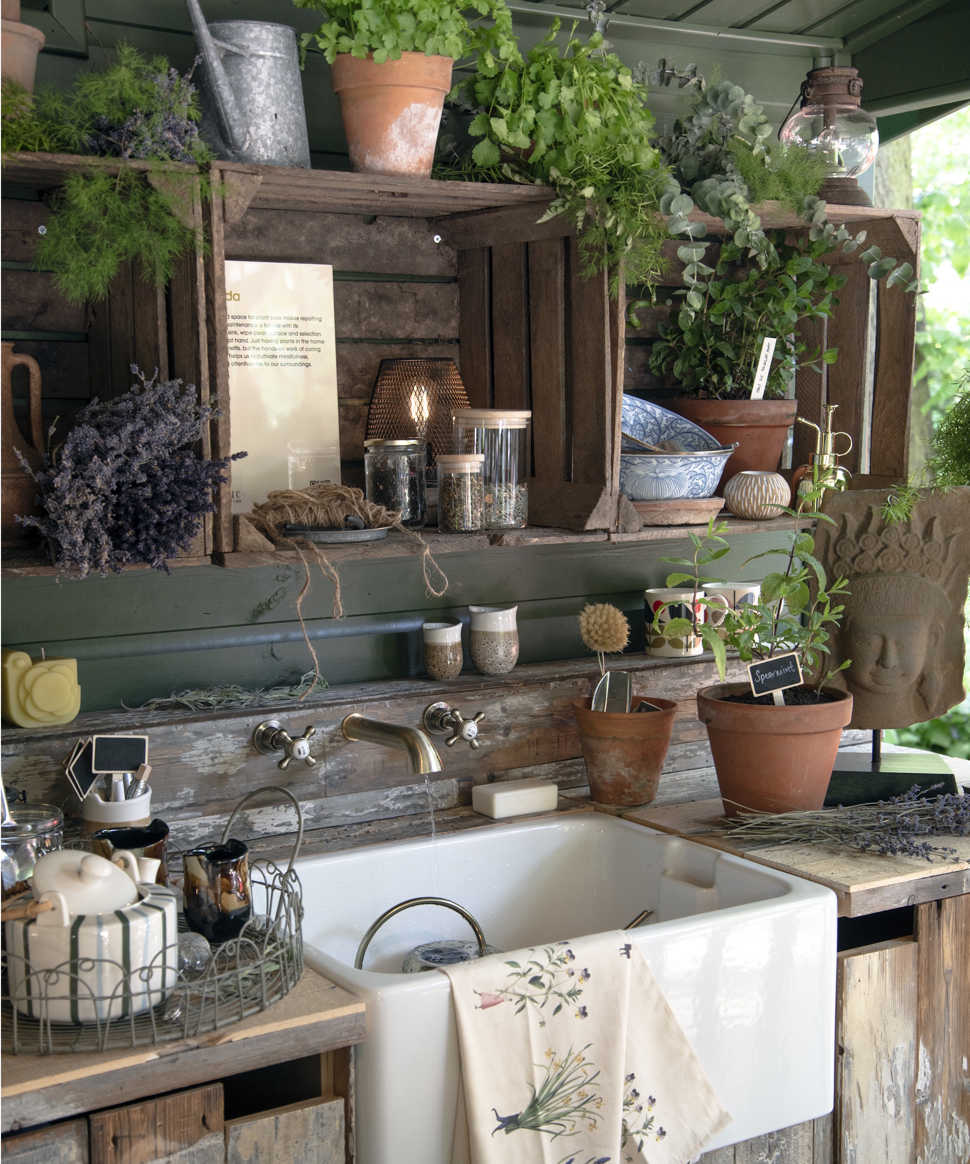 Potting shed sink with trinkets and pots surrounding it