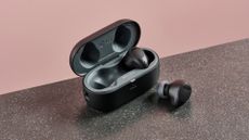 Right earbud of the LG Tone Free T90S in charging case with left earbud on counter