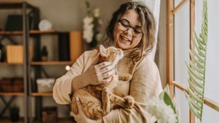 Woman cuddling her cat