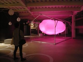 House-shaped frame around a large, lit, pink object