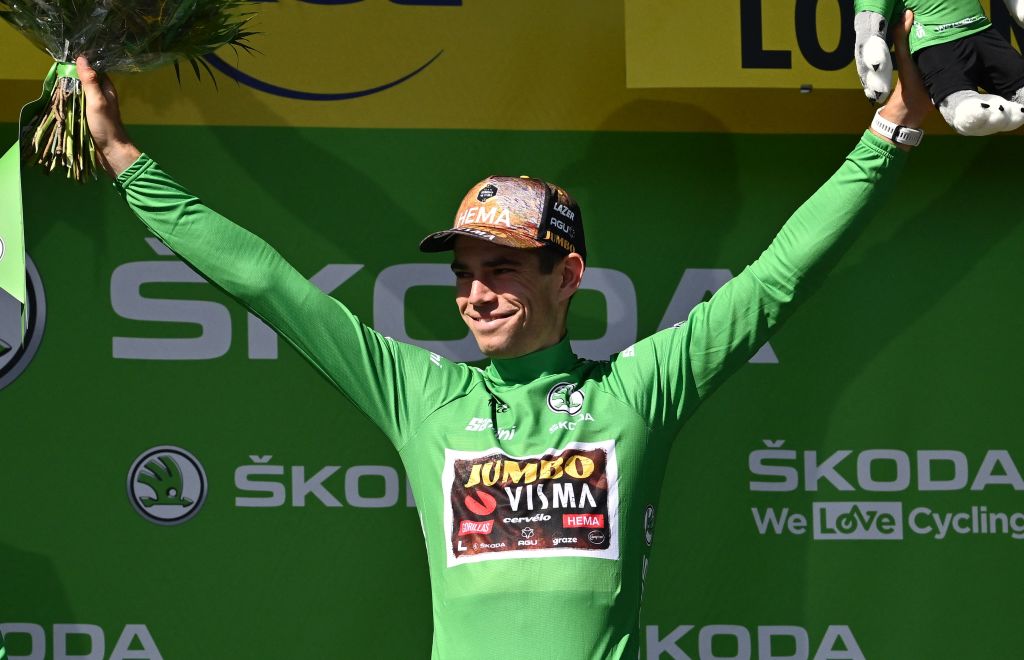 JumboVisma teams Belgian rider Wout Van Aert celebrates on the podium with the sprinters green jersey after the 14th stage of the 109th edition of the Tour de France cycling race 1925 km between SaintEtienne and Mende in central France on July 16 2022 Photo by Marco BERTORELLO AFP Photo by MARCO BERTORELLOAFP via Getty Images