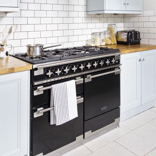 kitchen with white tiles and range cooker