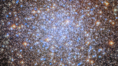 A cluster of brilliant white and golden stars shines in the darkness of space.