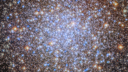 A cluster of brilliant white and golden stars shines in the darkness of space.