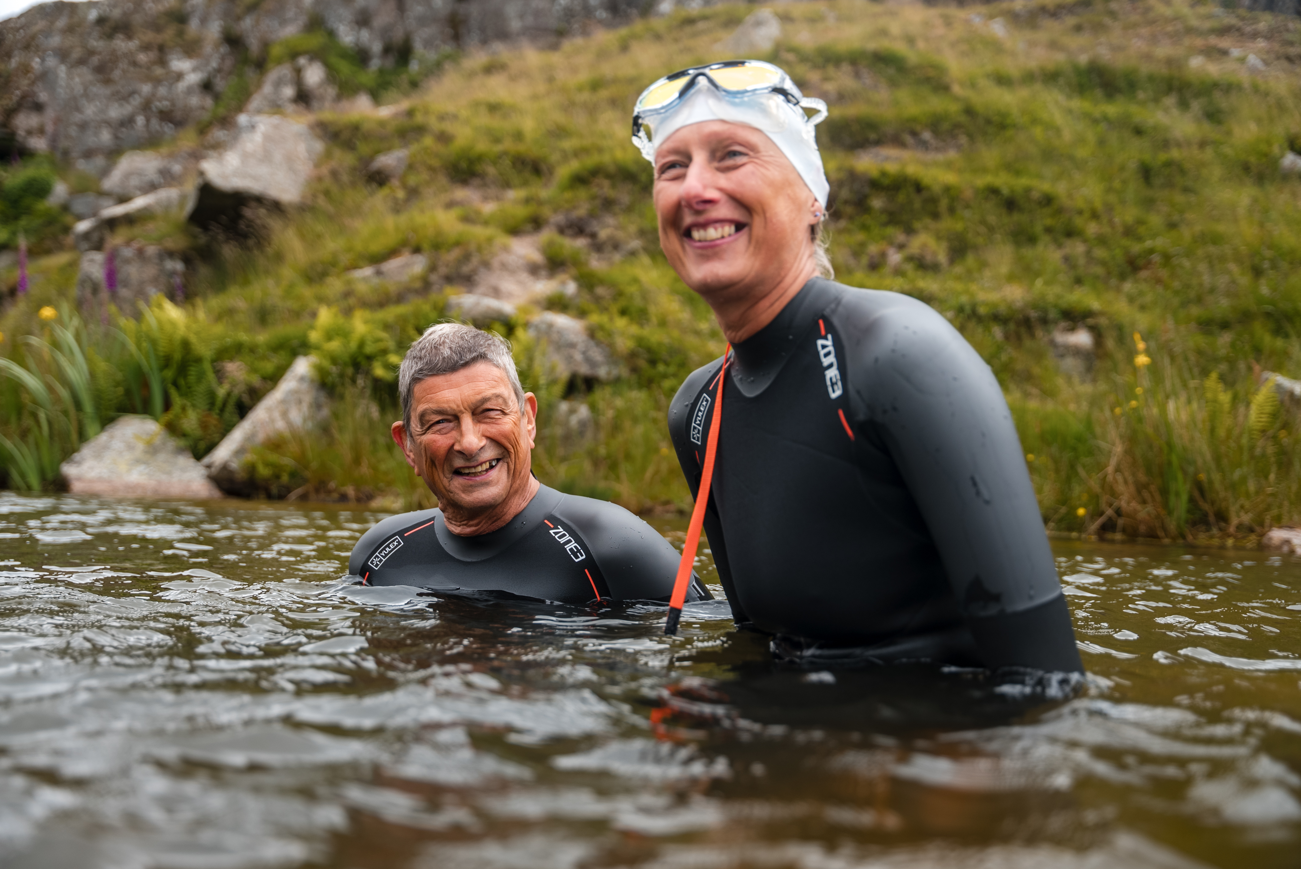 A couple both wearing the Zone3 Active-Flex wetsuit
