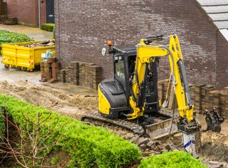 a digger in the garden during landscaping process