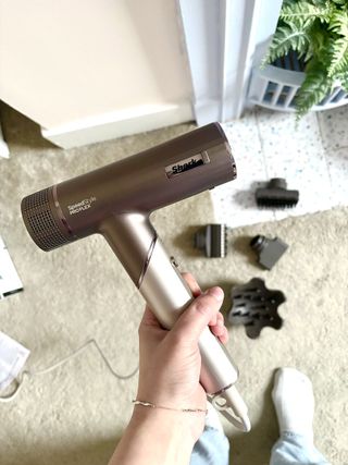 Mica Ricketts holding Shark SpeedStyle PRO Flex Hair Dryer