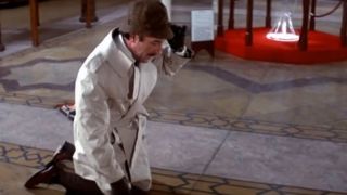 Peter Sellers on his knees inspecting the floor in The Pink Panther