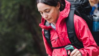 Woman hiking with red jacket