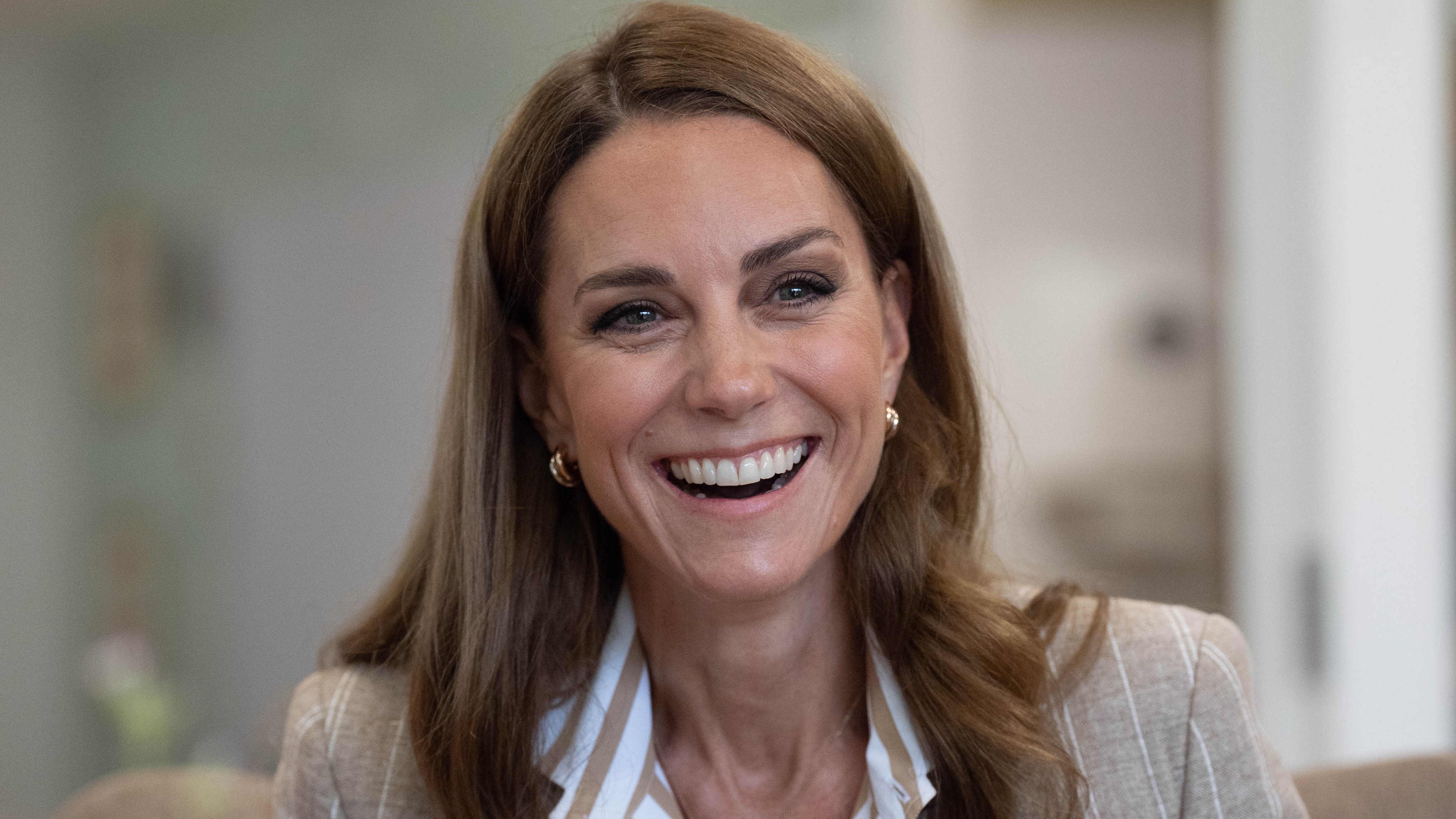 Catherine, Princess of Wales smiles, wearing tri-colour earrings, during a visit to the RHS&#039;s Wellbeing Garden at Colchester Hospital on July 2, 2025