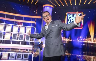 Alan Carr hosting Play Your Cards Right for his Epic Gameshow.