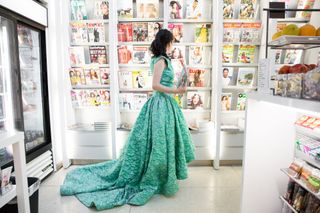 Wearing Gown Whilst Browsing Magazines in Shop