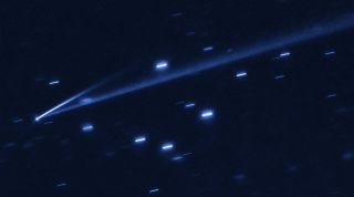 The asteroid (6478) Gault is seen with the NASA/ESA Hubble Space Telescope, showing two narrow, comet-like tails of debris that tell us that the asteroid is slowly undergoing self-destruction. The bright streaks surrounding the asteroid are background stars. 
