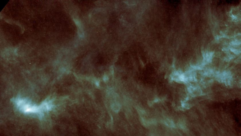 a pale green cloud of gas on a starry background