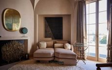 terracotta walls living room with ceiling arches, pink sofa and large artworks