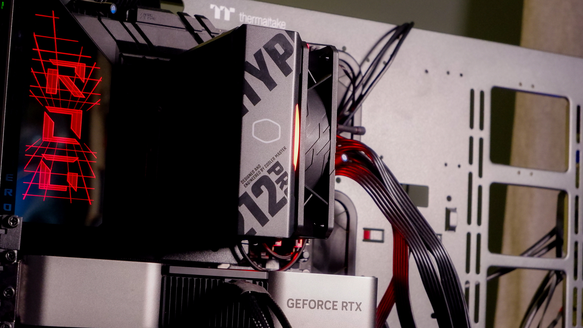 A Cooler Master Hyper 212 Pro air cooler with its packaging and installed on a gaming PC.
