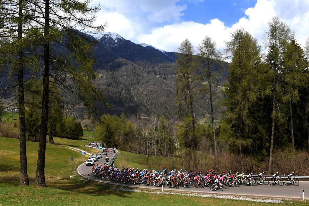 PIEVEDIBONO ITALY APRIL 22 The peloton passing through Dimaro 766m landscape during the 44th Tour of the Alps 2021 Stage 4 a 1686 to stage from Naturns to Valle del Chiese Pieve di Bono TourofTheAlps Mountains Snow Forest TouroftheAlps on April 22 2021 in Pieve di Bono Italy Photo by Tim de WaeleGetty Images