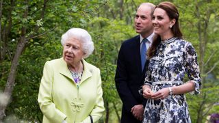 Catherine, Duchess of Cambridge (R) shows Britain's Queen Elizabeth II (L) and Britain's Prince William, Duke of Cambridge, around the 'Back to Nature Garden' garden