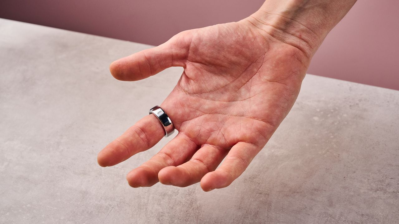 The Oura Ring 3 on a man's index finger, showing the palm side.