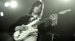 A black-and-white photo of Jeff Beck playing a white Strat in 1975