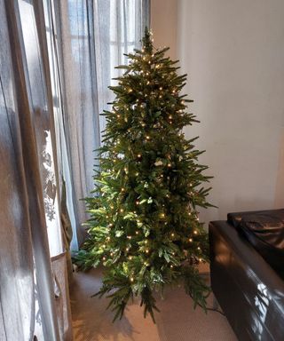 christmas tree decorated with lights using the vertical TikTok method