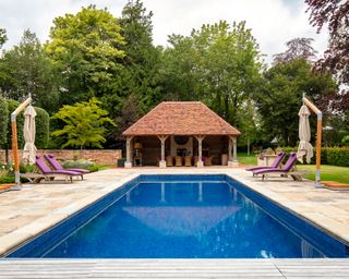 Swimming pool at a colorful country home in Sussex designed by Kate Forman