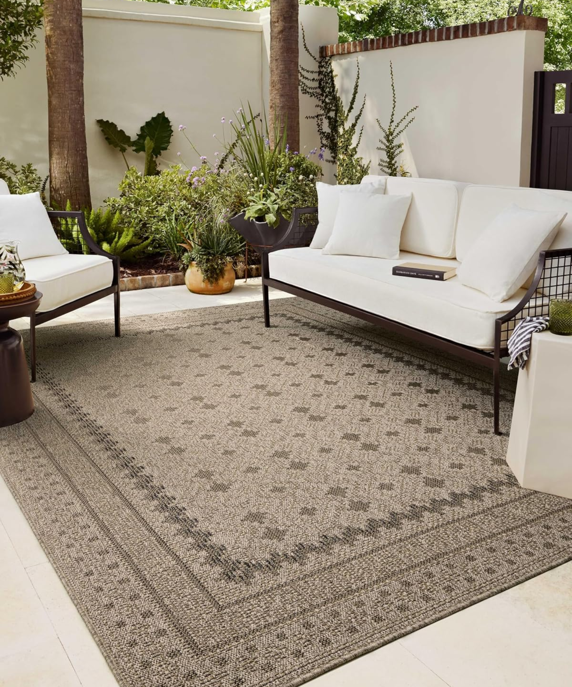 a decorative outdoor rug from amazon on a patio with patio furniture