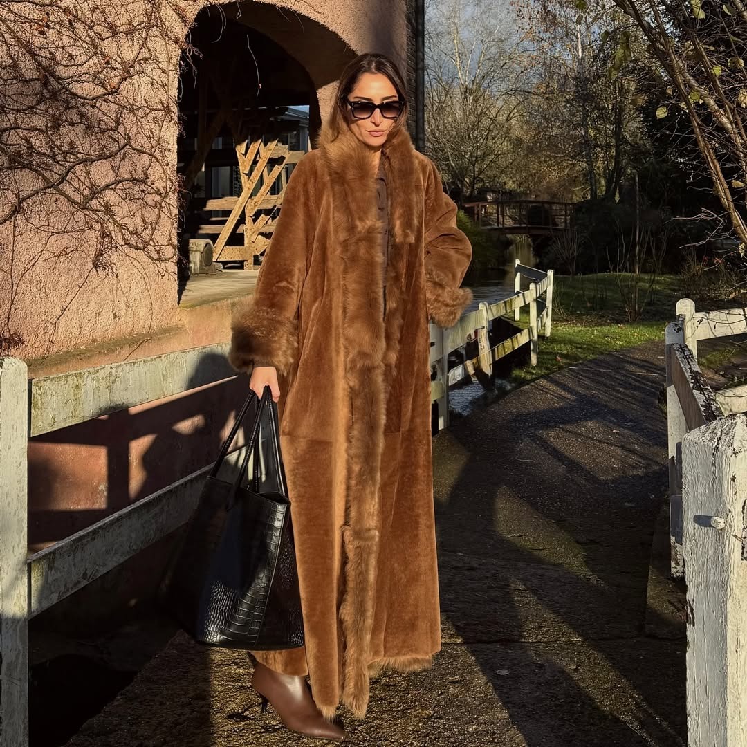 Woman wearing a long tan faux-fur coat