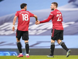 Manchester United’s Luke Shaw (right) celebrates scoring their side’s second goal of the game with team-mate Bruno Fernandes during the Premier League match at the Etihad Stadium, Manchester. Picture date: Sunday March 7, 2021
