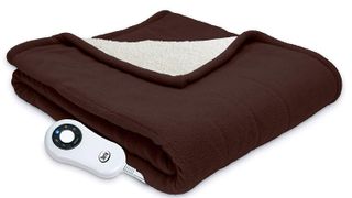 A brown electric blanket is folded up.