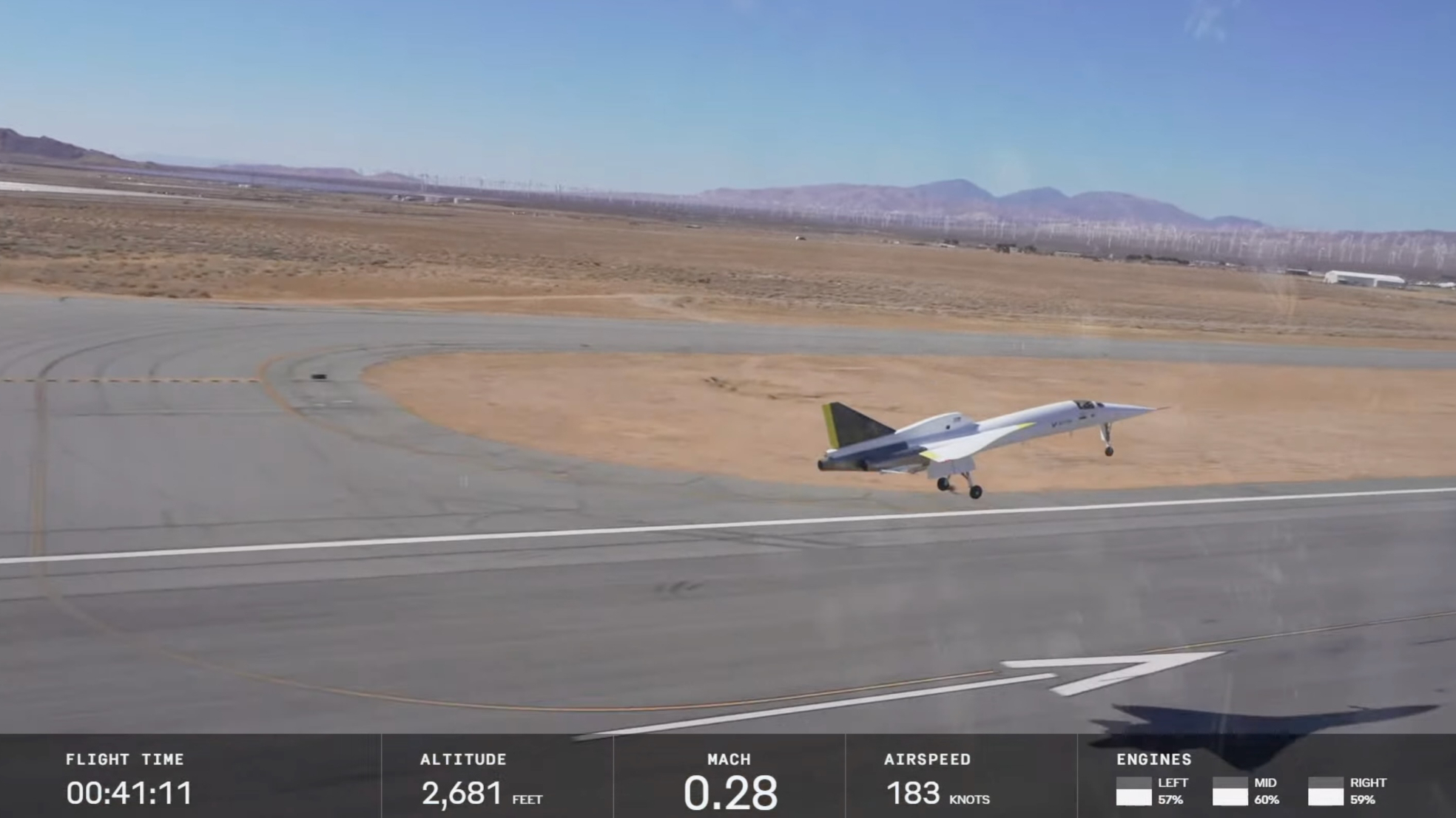 a small white jet lands at a desert runway