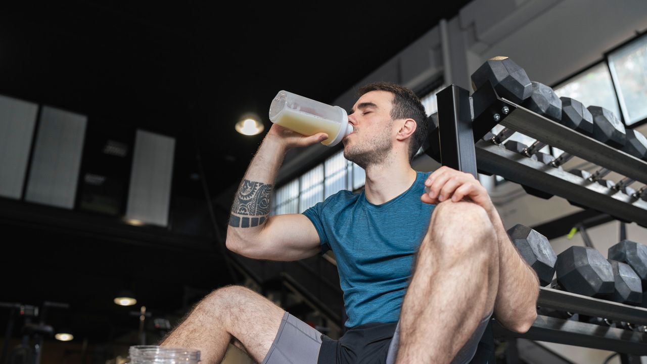 A man drinking protein