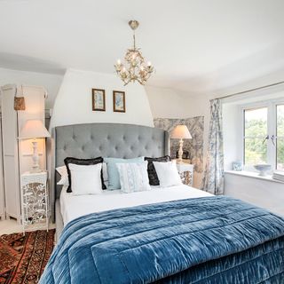 bedroom with photoframe on white wall and bed with pillows