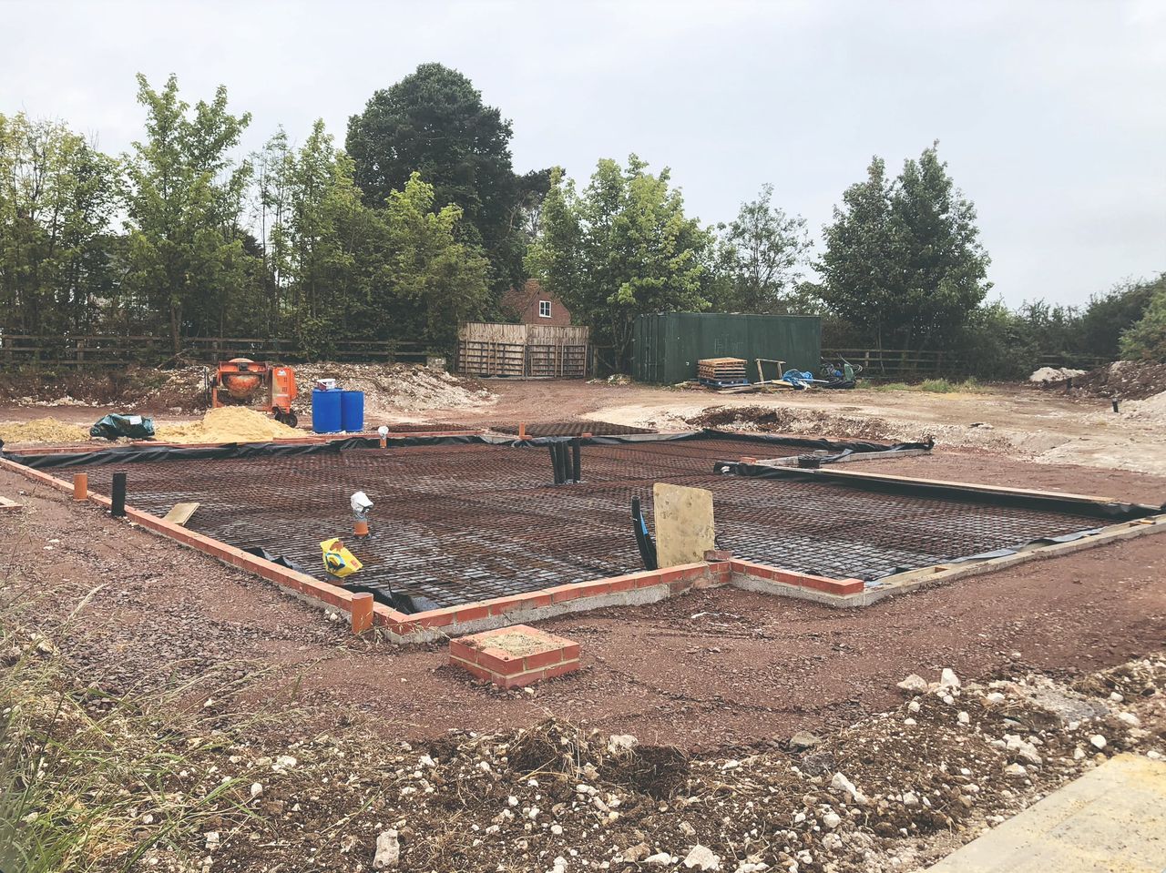 A construction site where a reinforced concrete slab is being laid