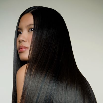 a woman with smooth keratin treated hair looking into the distance
