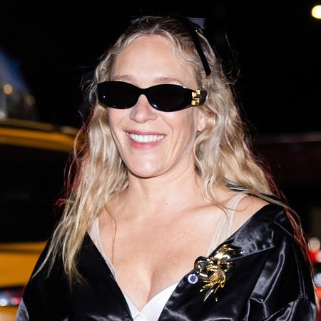 Chloë Sevigny wearing a black satin coat and sunglasses in NYC