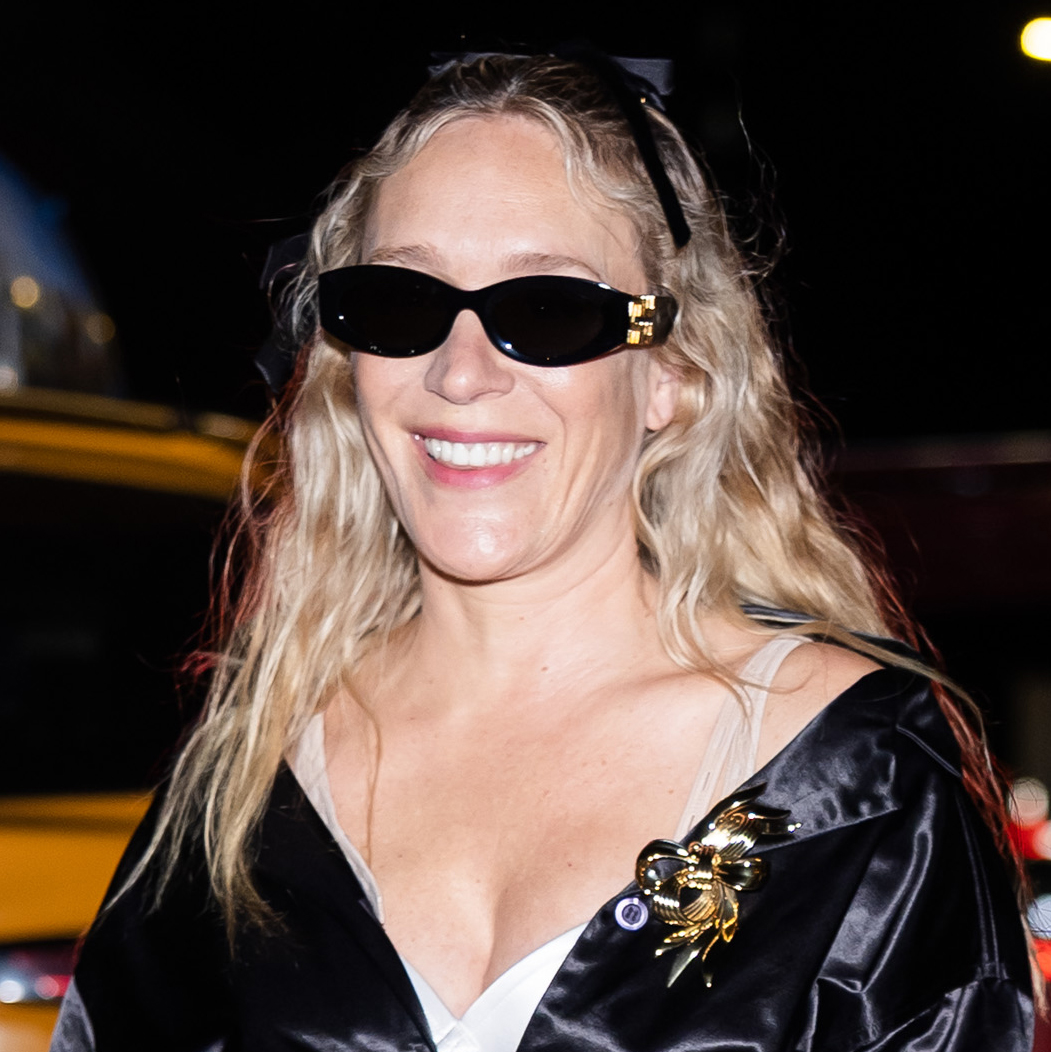 Chloë Sevigny wearing a black satin coat and sunglasses in NYC