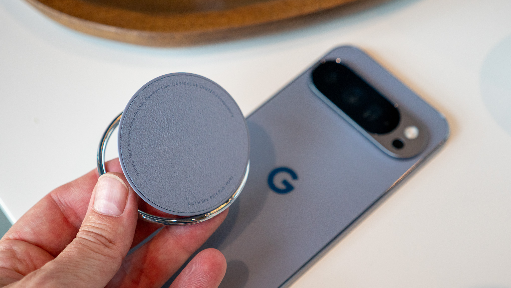 A Google Pixelsnap ring attached to the back of the Google Pixel 10 Pro XL via Qi2 magnets