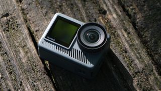 Akaso Brave 8 Lite action camera on a wooden surface outside