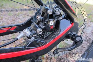 The rear brake caliper nestles between the seat- and chainstay