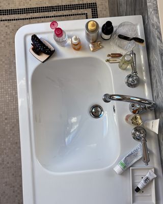 @emmahoareau bathroom sink with products on top